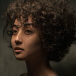 Artistic Photo of Young Attractive Woman with Curly Hair