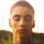 Man with Green Leaves on His Face
