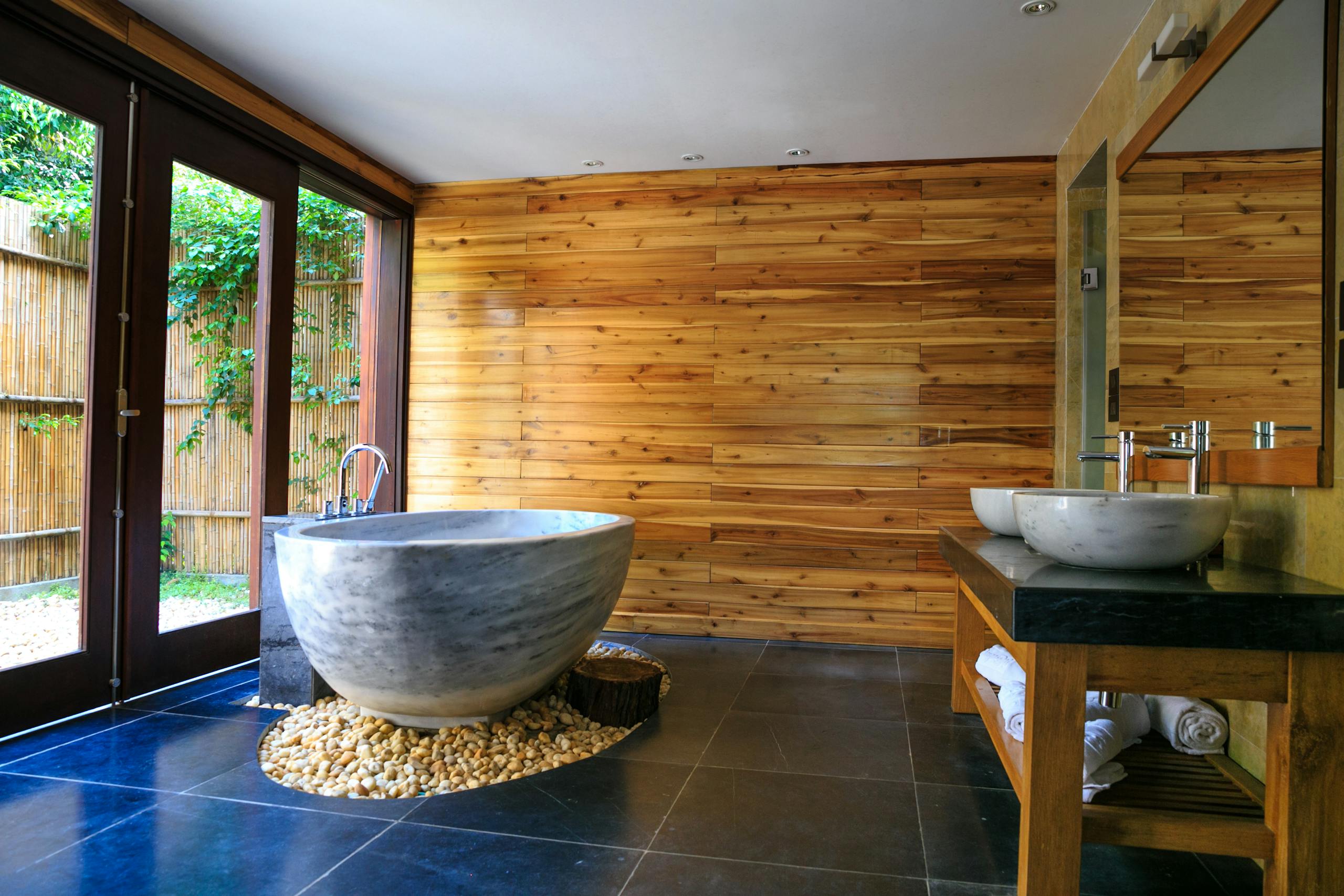 Round White and Gray Ceramic Bathtub Inside Brown Room